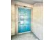 Condo front door painted in a bright turquoise color and numbered with 'B2' above it at 6344 Newtown Cir # B2, Tampa, FL 33615