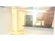 Kitchen pass through with granite countertops and sink, and view to the laundry area at 6344 Newtown Cir # B2, Tampa, FL 33615