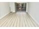 Bright living room featuring sliding glass doors, laminate floors, and neutral paint at 6344 Newtown Cir # B2, Tampa, FL 33615