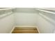 Bright walk-in closet features built-in shelving and modern, light-colored wood flooring at 6344 Newtown Cir # B2, Tampa, FL 33615