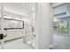 Modern bathroom featuring glass shower, dual vanity, and natural light at 6605 N Nebraska Ave # 23, Tampa, FL 33604