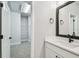 Bright bathroom featuring a white vanity with a quartz countertop, modern black fixtures, and an open closet at 6605 N Nebraska Ave # 23, Tampa, FL 33604