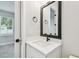 Modern bathroom featuring a vanity with a black faucet and a rectangular mirror at 6605 N Nebraska Ave # 23, Tampa, FL 33604