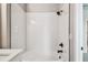 Bathroom featuring a modern white tiled shower and black fixtures at 6605 N Nebraska Ave # 23, Tampa, FL 33604