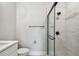 Contemporary bathroom with a glass-enclosed shower, black fixtures, and gray tile at 6605 N Nebraska Ave # 23, Tampa, FL 33604