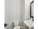 Powder room featuring a toilet and pedestal sink with a black faucet and mirror at 6605 N Nebraska Ave # 23, Tampa, FL 33604