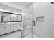 Modern bathroom featuring glass-enclosed shower, and large mirror above double sink vanity at 6605 N Nebraska Ave # 23, Tampa, FL 33604