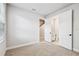 Clean, carpeted bedroom with white walls, a closet and an attached bathroom at 6605 N Nebraska Ave # 23, Tampa, FL 33604