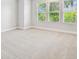 Bedroom featuring plush carpet, three large windows, and neutral color palette at 6605 N Nebraska Ave # 23, Tampa, FL 33604