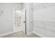 Walk-in closet leading to a tiled bathroom, equipped with practical wire shelving at 6605 N Nebraska Ave # 23, Tampa, FL 33604
