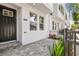 Charming entryway of a townhome showcasing a black front door and well-maintained landscaping at 6605 N Nebraska Ave # 23, Tampa, FL 33604