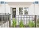 Inviting front entrance featuring a black front door, stone pathway, and manicured landscaping at 6605 N Nebraska Ave # 23, Tampa, FL 33604