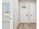 Stylish entryway with wood-look floors and a view into a carpeted room at 6605 N Nebraska Ave # 23, Tampa, FL 33604