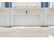 Attached white garage door, featuring exterior lighting and house number at 6605 N Nebraska Ave # 23, Tampa, FL 33604