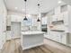 A kitchen featuring a kitchen island with stainless steel appliances and white cabinetry at 6605 N Nebraska Ave # 23, Tampa, FL 33604