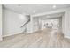 Open-concept living space featuring modern flooring, staircase, and view into a modern kitchen at 6605 N Nebraska Ave # 23, Tampa, FL 33604