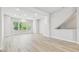 Open-concept living room with three large windows and durable wood-look flooring at 6605 N Nebraska Ave # 23, Tampa, FL 33604