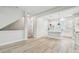 Open-concept living room with wood-look flooring and bright, neutral paint at 6605 N Nebraska Ave # 23, Tampa, FL 33604