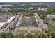 Community aerial view shows townhouses, condominiums, pond, tennis courts and lush landscaping at 8158 Eagles Park N Dr, St Petersburg, FL 33709