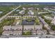 Aerial view of community with townhouses, condominiums, pond, pools, tennis courts, and lush landscaping at 8158 Eagles Park N Dr, St Petersburg, FL 33709