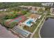 Aerial view of tennis courts, pool, shuffleboard and pond located within the community at 8158 Eagles Park N Dr, St Petersburg, FL 33709