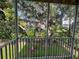 Screened balcony overlooking trees and foliage at 8158 Eagles Park N Dr, St Petersburg, FL 33709