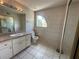 Standard bathroom features a vanity with a sink, a toilet, and a mirror sliding-door closet at 8158 Eagles Park N Dr, St Petersburg, FL 33709
