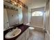Bathroom with a vanity and a shower over bath tub with a large window at 8158 Eagles Park N Dr, St Petersburg, FL 33709
