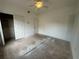Spacious bedroom featuring a ceiling fan and closet with double doors at 8158 Eagles Park N Dr, St Petersburg, FL 33709