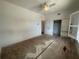 Spacious bedroom featuring a ceiling fan, closet with doors, and shuttered window at 8158 Eagles Park N Dr, St Petersburg, FL 33709