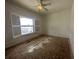 Spacious bedroom featuring a ceiling fan and shuttered window at 8158 Eagles Park N Dr, St Petersburg, FL 33709