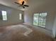 Bedroom with a ceiling fan and glass sliding doors to the balcony at 8158 Eagles Park N Dr, St Petersburg, FL 33709