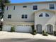 Well-maintained two-story home featuring a multi-car garage and inviting front entrances at 8158 Eagles Park N Dr, St Petersburg, FL 33709