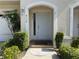 Inviting front door with arched entryway and manicured landscaping at 8158 Eagles Park N Dr, St Petersburg, FL 33709