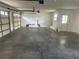 Bright garage with a concrete floor, features two garage doors, white walls and a service door at 8158 Eagles Park N Dr, St Petersburg, FL 33709