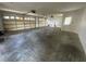 Spacious two car garage with roll up doors, white walls and a concrete floor at 8158 Eagles Park N Dr, St Petersburg, FL 33709