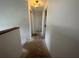 Bright hallway with a light fixture, white walls, and flooring being renovated at 8158 Eagles Park N Dr, St Petersburg, FL 33709