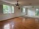 Large living area featuring hardwood floors, natural light, and views to the outside balcony at 8158 Eagles Park N Dr, St Petersburg, FL 33709