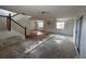 Spacious living room with staircase, natural light, and a combination of wood and unfinished floors at 8158 Eagles Park N Dr, St Petersburg, FL 33709