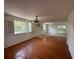 Bright living room with hardwood floors, modern light fixtures, and access to the outdoor balcony at 8158 Eagles Park N Dr, St Petersburg, FL 33709