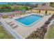 The community pool features lounge chairs, tables and chairs, and a fenced-in perimeter at 8158 Eagles Park N Dr, St Petersburg, FL 33709