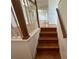 Staircase with hardwood steps and white railing leading to the living area at 8158 Eagles Park N Dr, St Petersburg, FL 33709
