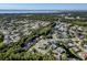 A beautiful lake view from above showcases a community with greenery and landscaping surrounding each house at 910 Kingscote Ct, Safety Harbor, FL 34695