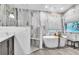 Elegant bathroom features a stand alone tub, modern fixtures, and neutral paint at 910 Kingscote Ct, Safety Harbor, FL 34695