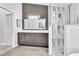 Modern bathroom features dual sinks, marble shower, and neutral paint at 910 Kingscote Ct, Safety Harbor, FL 34695