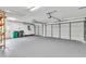Spacious three-car garage with ample room for vehicles and storage at 910 Kingscote Ct, Safety Harbor, FL 34695