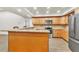Kitchen with wood cabinets, granite countertops, and stainless steel appliances provides a modern culinary experience at 910 Kingscote Ct, Safety Harbor, FL 34695