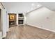 Bright living room features wood floors, stone fireplace, ceiling fan, and neutral paint at 910 Kingscote Ct, Safety Harbor, FL 34695