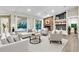 Open living room with fireplace, built-in shelving, and floor to ceiling windows offering backyard views at 910 Kingscote Ct, Safety Harbor, FL 34695