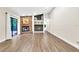 Spacious living room with wood floors, stone fireplace, and sliding glass doors to the backyard at 910 Kingscote Ct, Safety Harbor, FL 34695